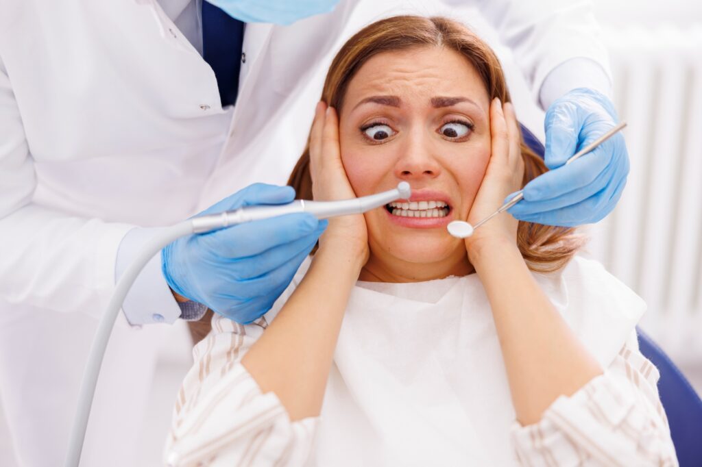 Nervous woman in dental chair during exam, illustrating dental anxiety before sedation dentistry at Creve Coeur Family & Sedation Dentistry in MO.