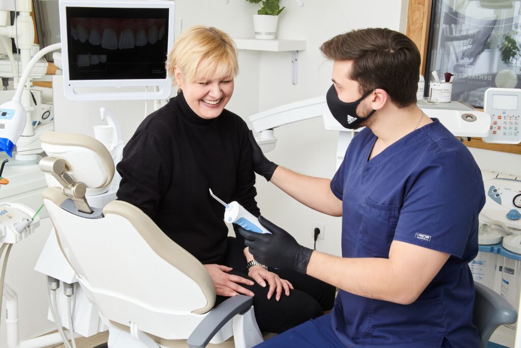 Patient speaking with a compassionate dentist during a welcoming consultation after returning to dental care.